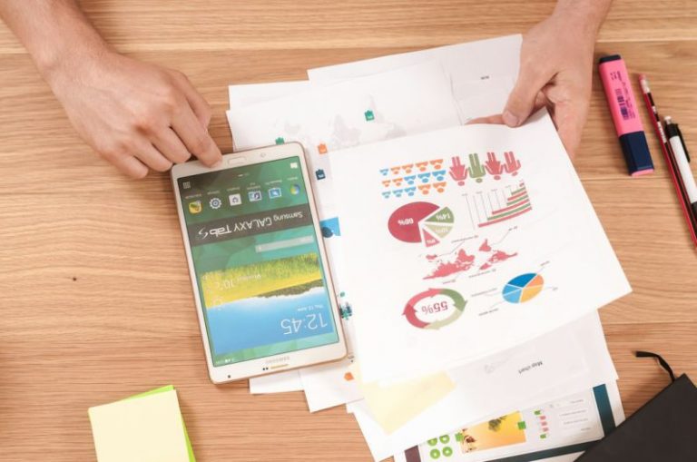 Investment Strategies - person holding white Samsung Galaxy Tab