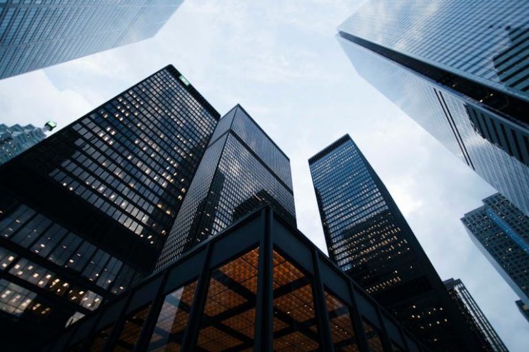 Real Estate Investments - low angle photo of city high rise buildings during daytime