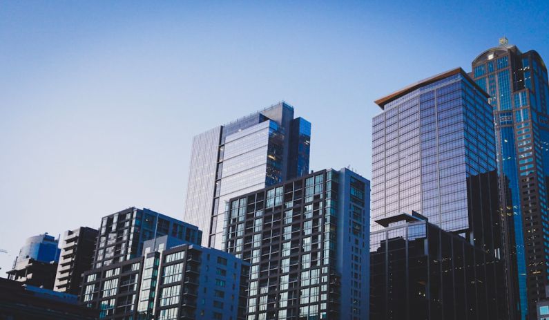 Real Estate - white and blue glass walled high rise building