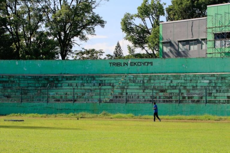 Emerging Real Estate Markets - a man walking across a lush green field