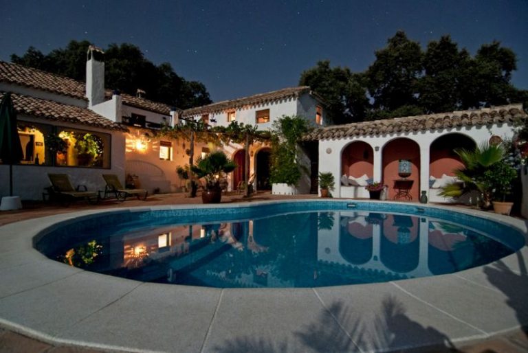 Real Estate Investments - white concrete house surrounded by trees