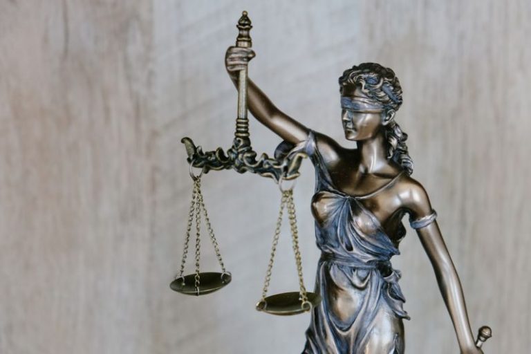 Legal Aspects - woman holding sword statue during daytime