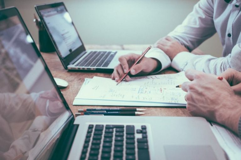 Financing Options - person holding pencil near laptop computer