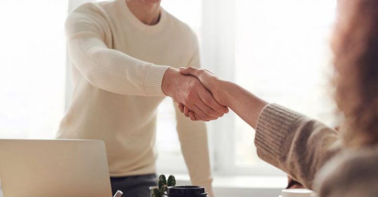 Negotiation Tactics - Man and Woman Near Table
