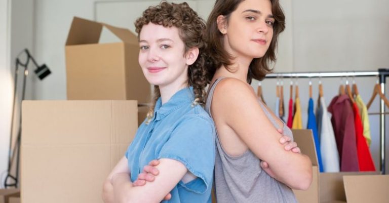 Sellers - A Woman in Blue Button-Up Shirt Standing Beside a Woman in Gray Tank Top