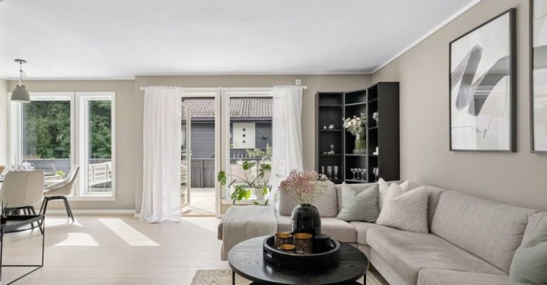 Rental Properties - A living room with a large window and a couch
