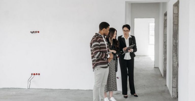 Landlords - Couple Looking at Real Estate Agent Documents