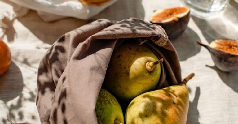 Eco-Friendly Features - Bags with Fresh Fruits and a Glass of Water Standing in Sunlight